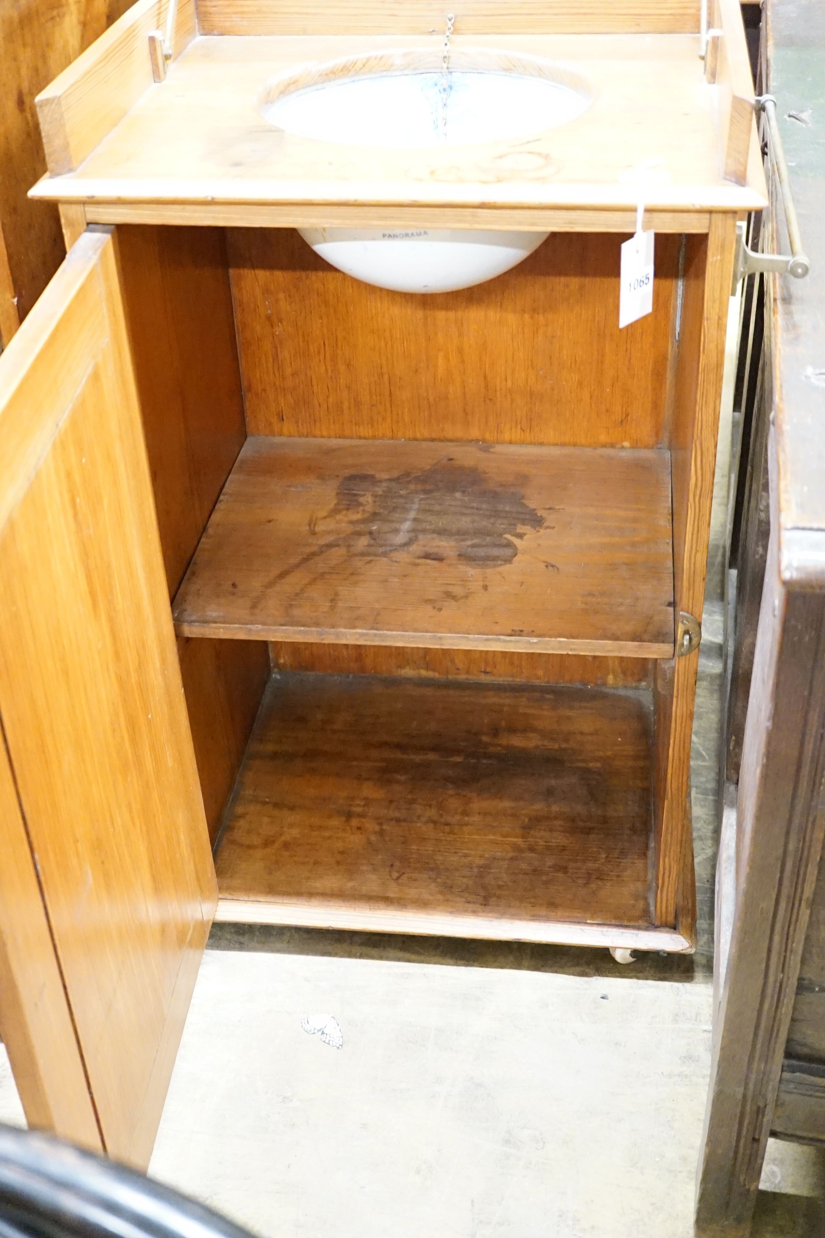 A late Victorian pitch pine wash stand with mirrored folding lid and blue and white printed basin (a.f.), width 58cm